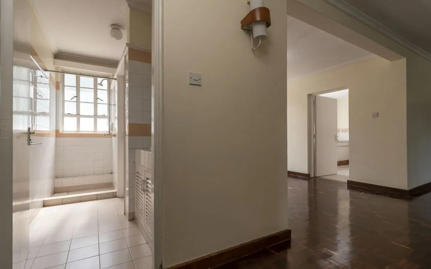 Bright corridor with multiple room entrances and windows