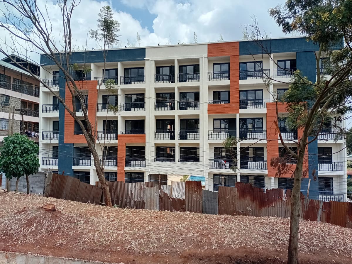 Modern multi-story residential apartment building with orange and blue facade