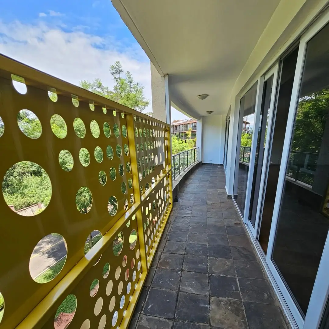 Modern balcony with decorative screening and garden views