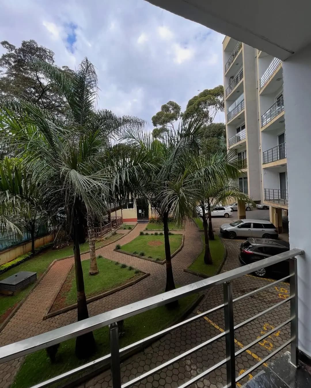 Courtyard garden view from balcony with palm trees