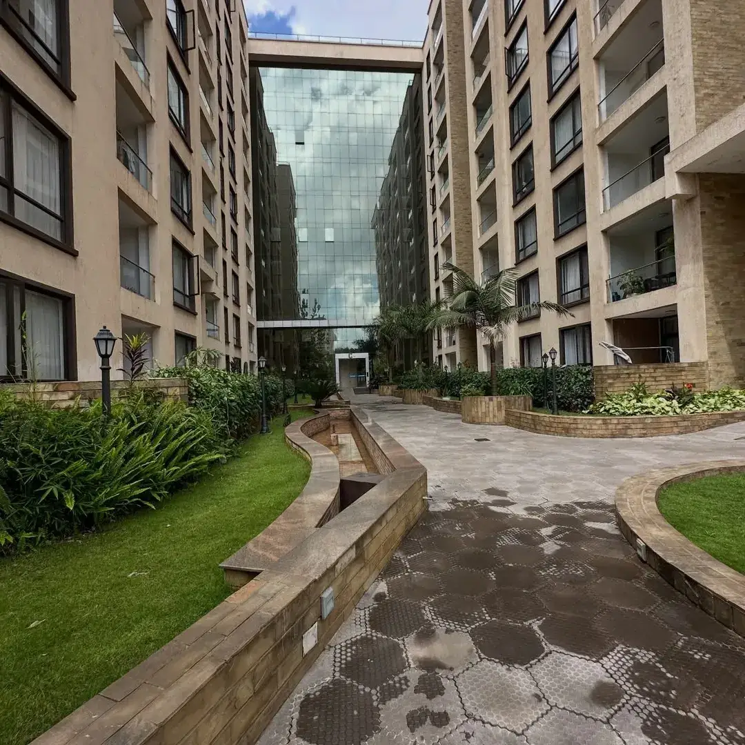 Multi-story residential compound with manicured lawns and landscaping