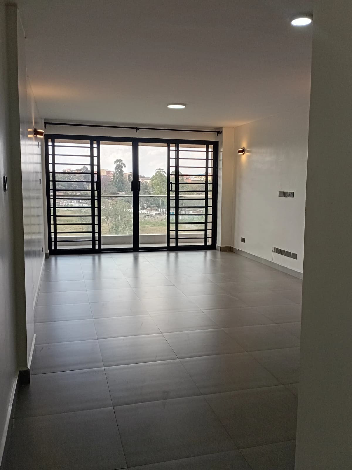 Spacious living room with large sliding doors to balcony