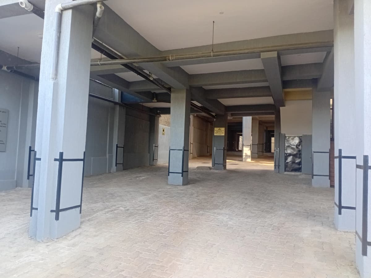 Large empty lobby with concrete flooring and support columns