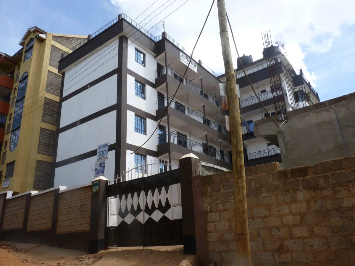 Multi-story residential building facade with perimeter wall