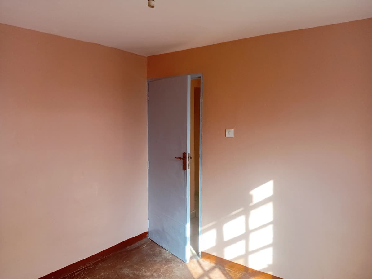 Empty bedroom with peach walls and natural light