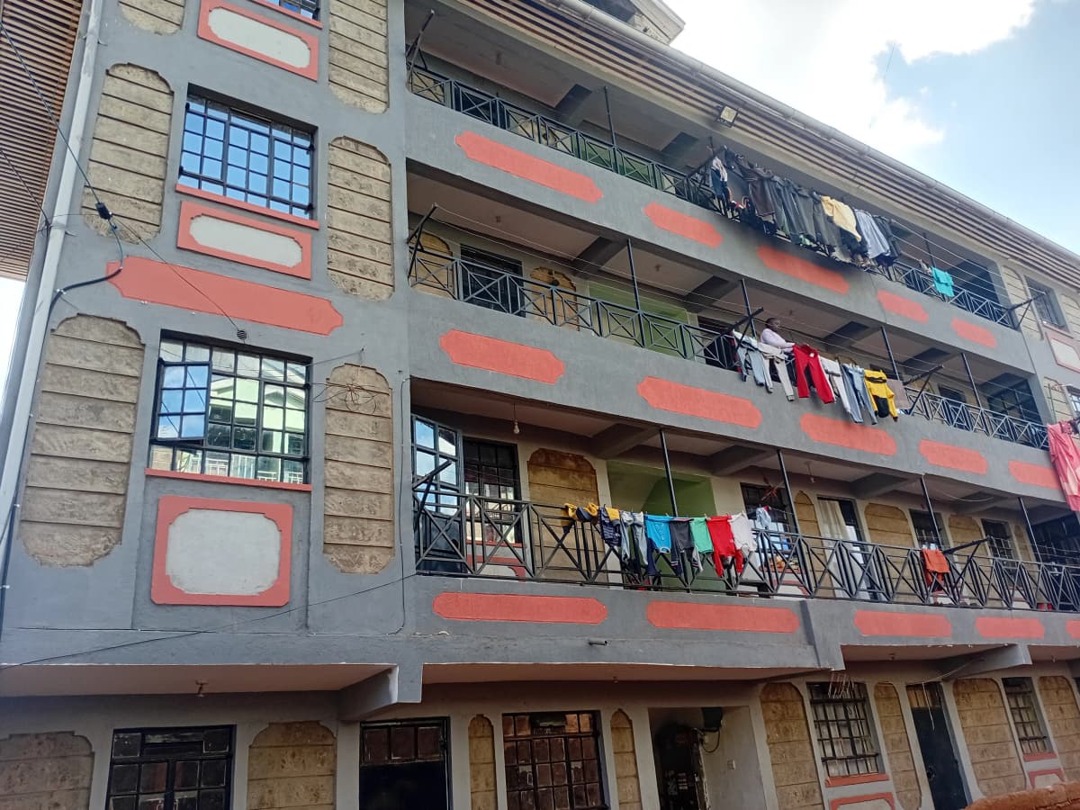 Multi-story residential building facade with balconies and laundry
