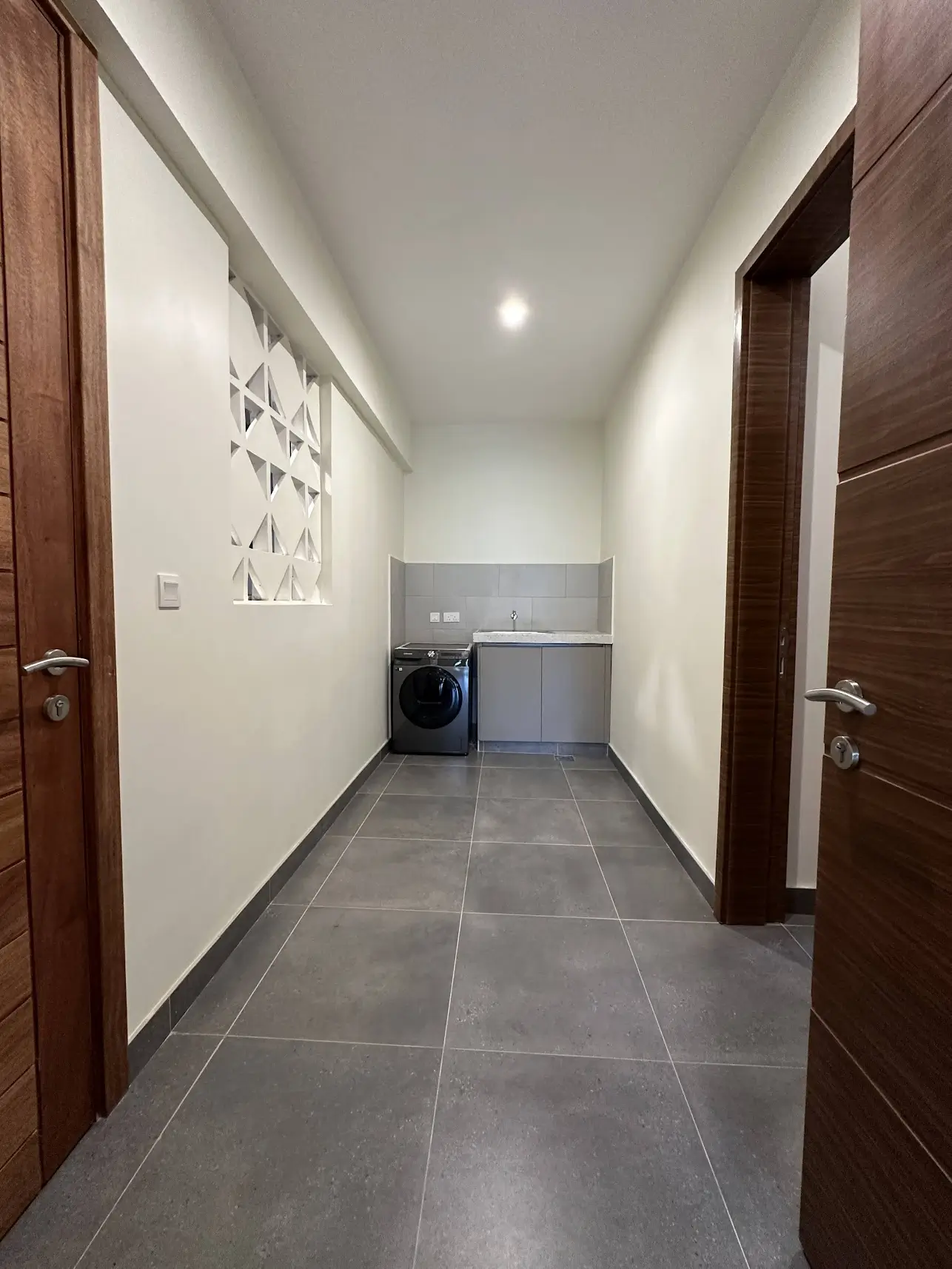 Modern laundry room with washing machine and utility sink