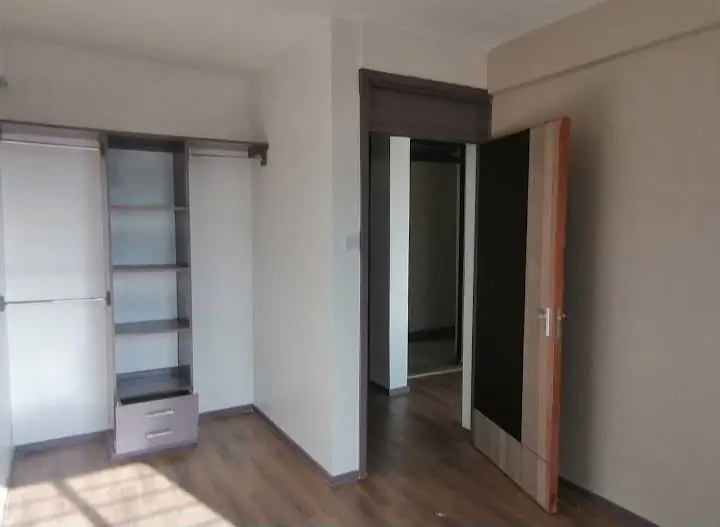 Spacious bedroom with built-in wardrobe and natural light