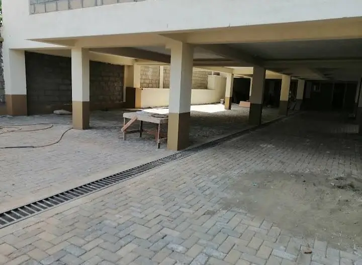 Covered parking area with paved compound and support columns