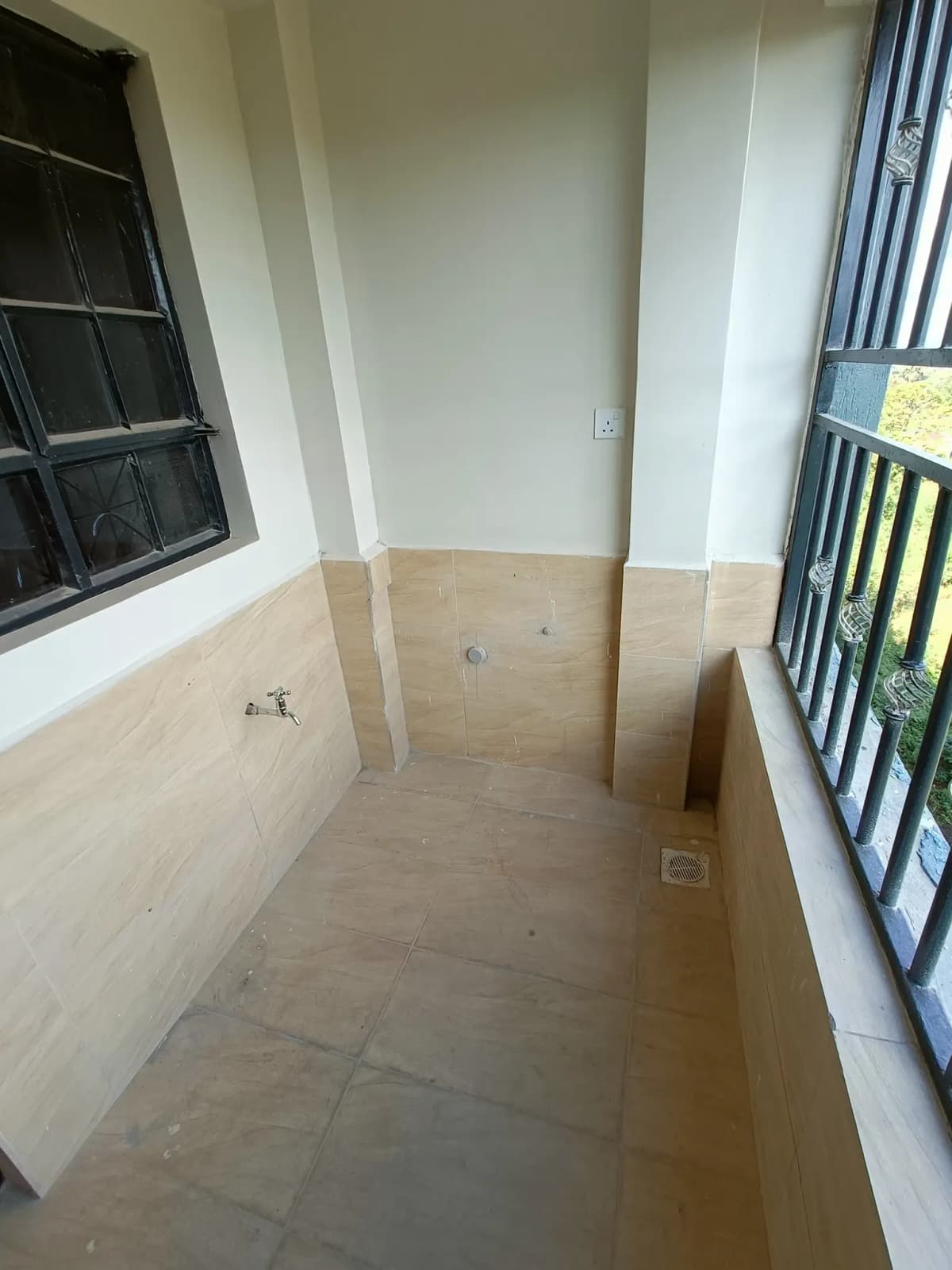 Narrow balcony or veranda with tiled flooring and railings