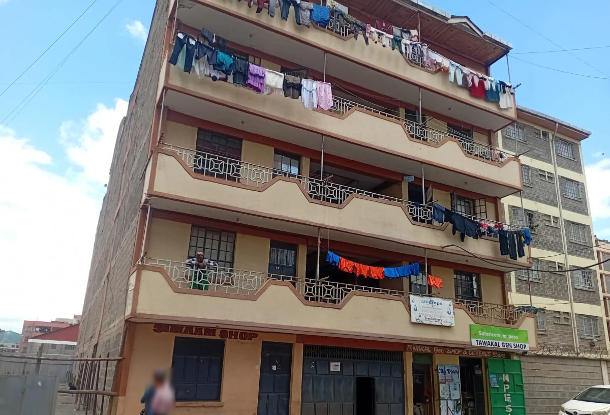 Multi-story residential building facade with balconies and clotheslines
