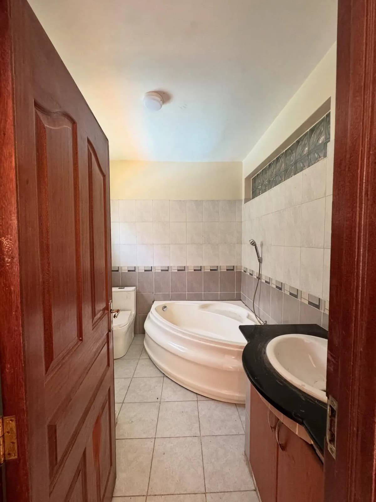 Spacious bathroom with corner bathtub and dual vanity sinks
