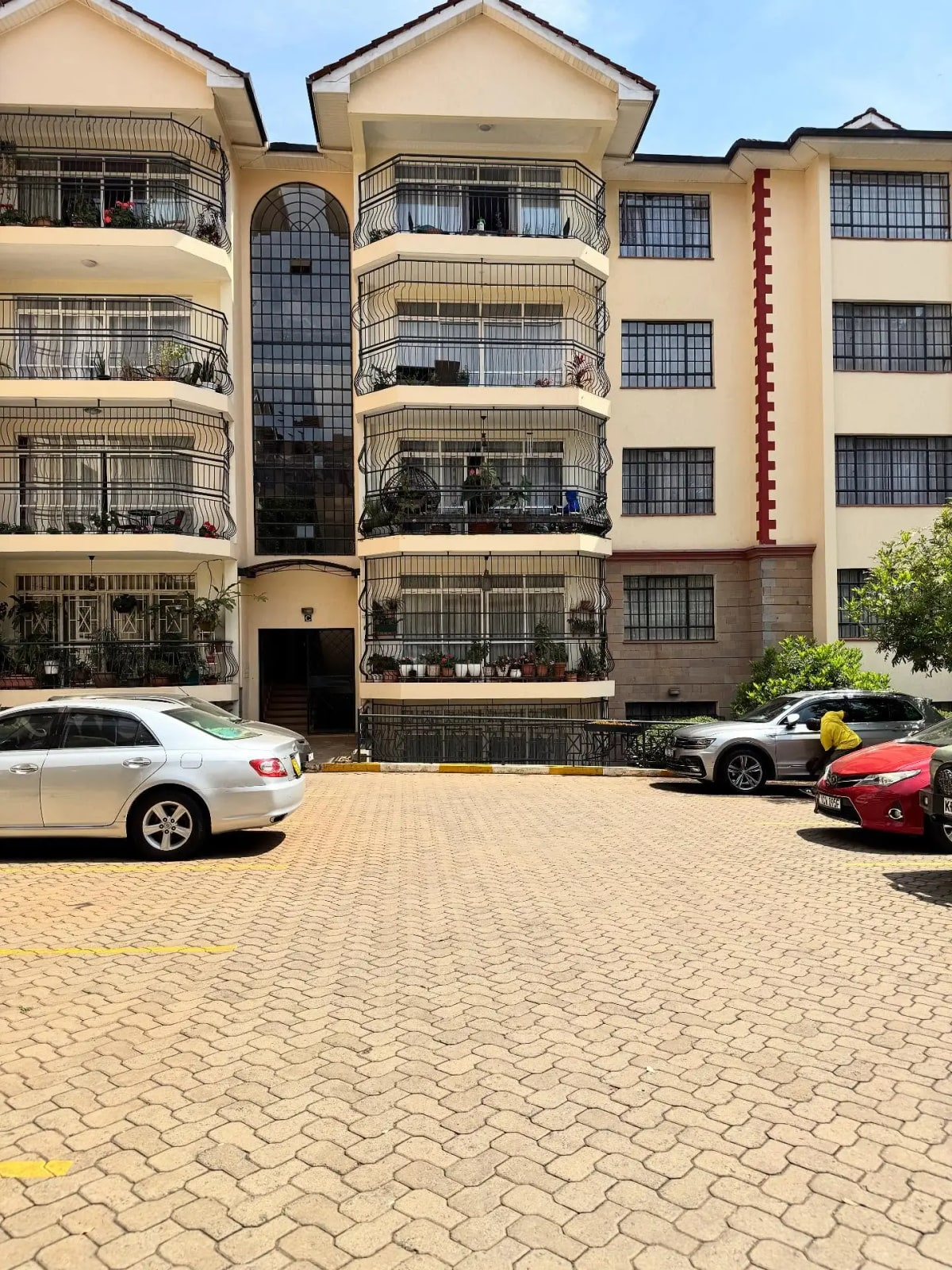Multi-story residential building with paved parking compound