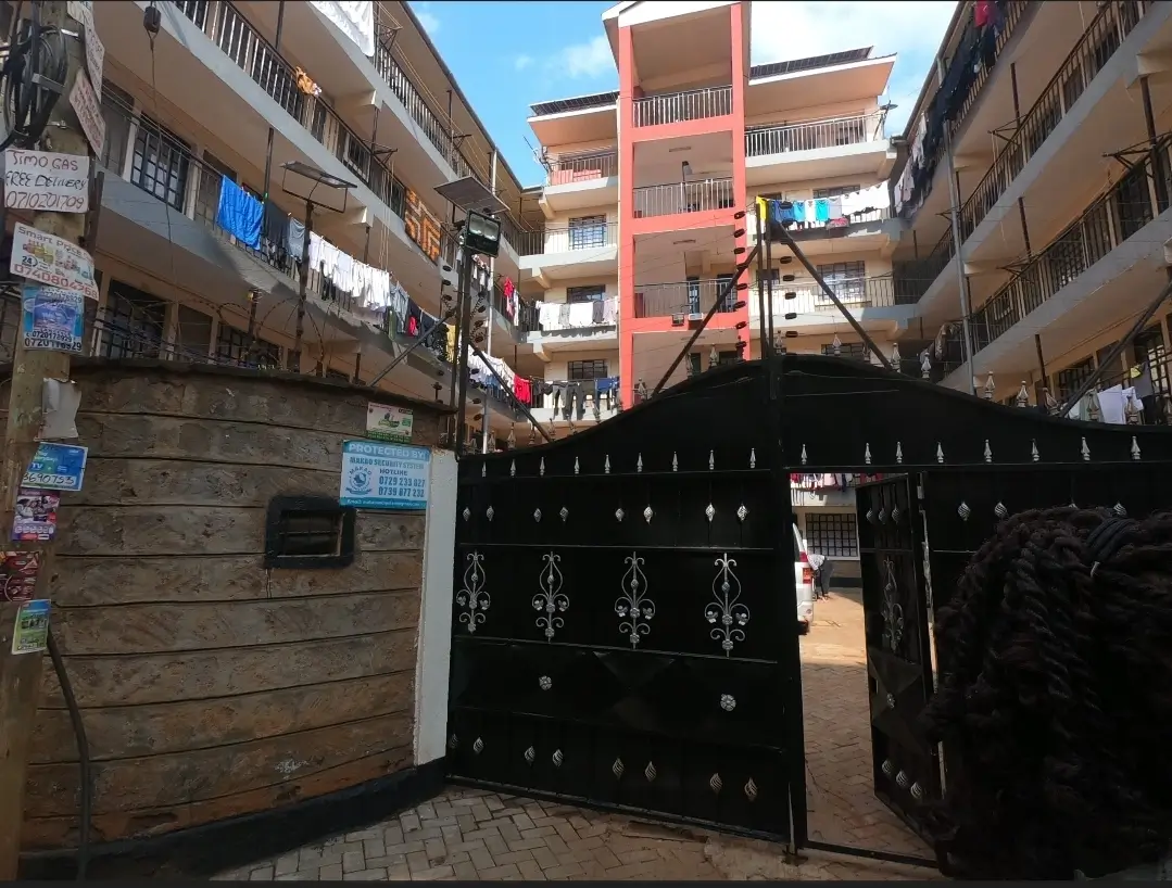 Black metal gates and compound entrance of residential building