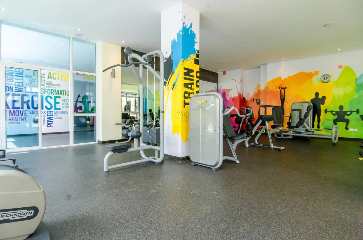Modern gym with cardio equipment and colorful wall murals