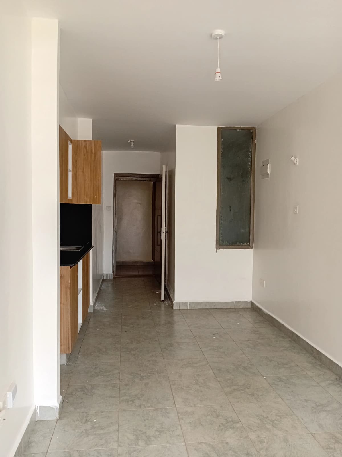 Open corridor with kitchen unit visible on left side