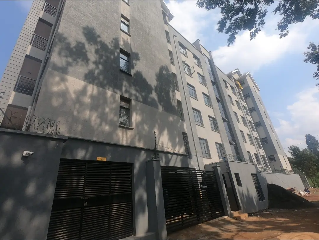 Multi-story residential building facade with ground-level parking