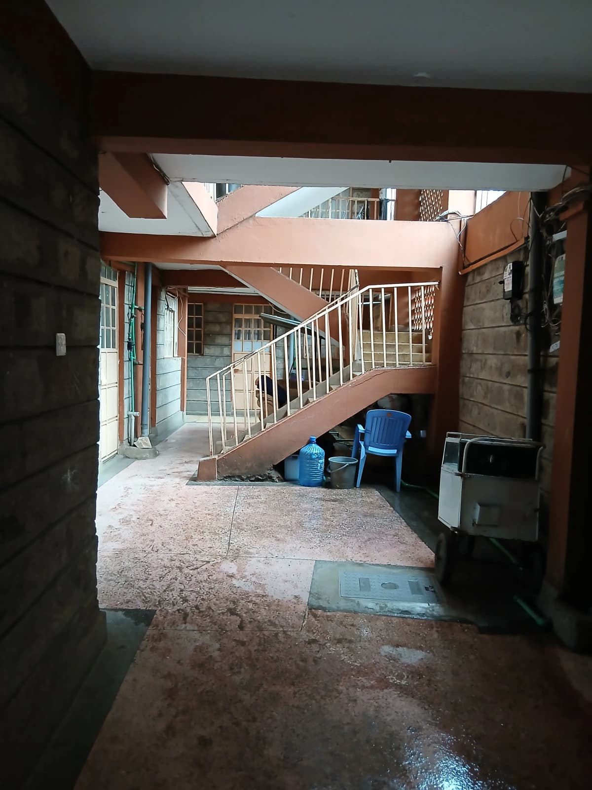 Building lobby with internal staircase and utility storage