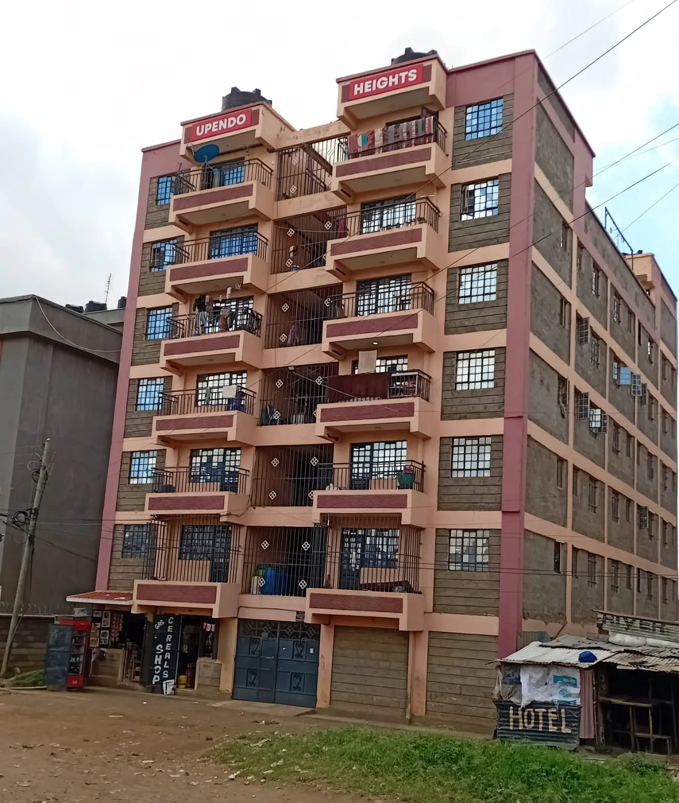 Multi-story residential building facade with balconies and signage