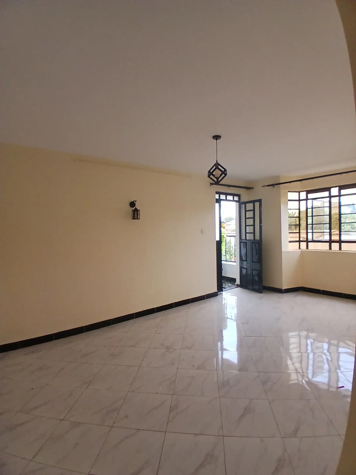 Spacious empty living room with polished tile flooring