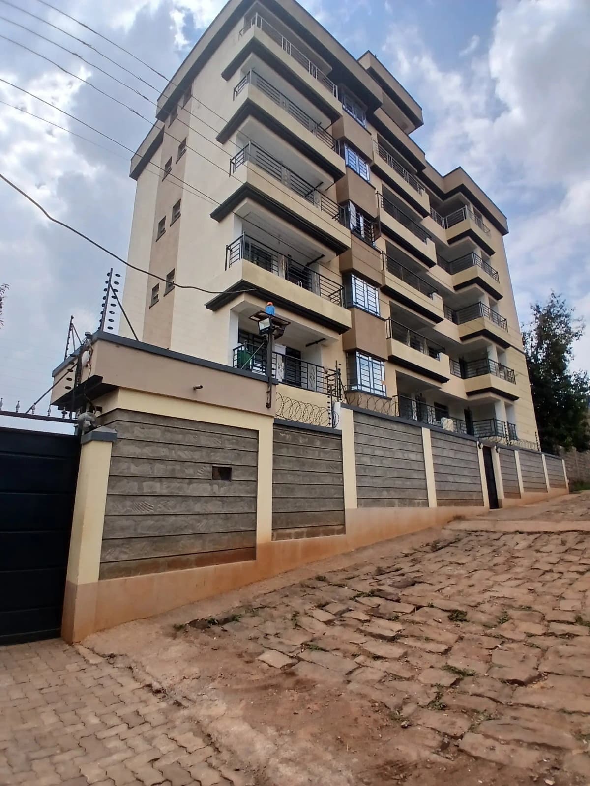 Multi-story residential building facade with secure gated entrance