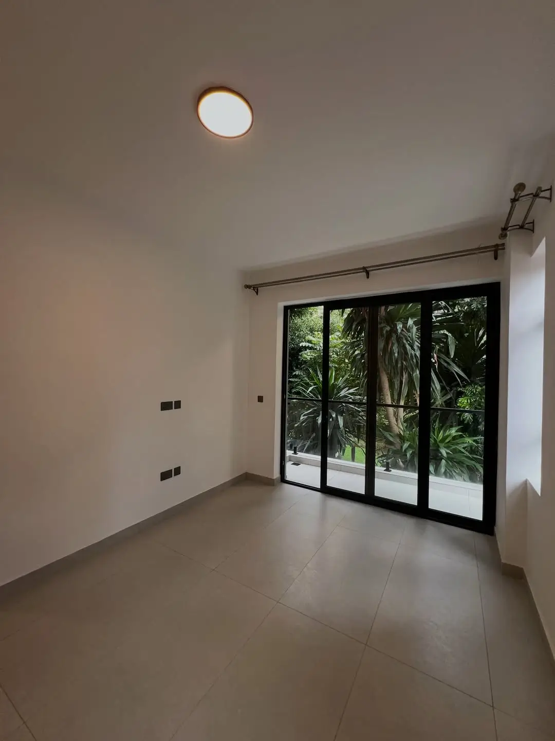 Interior room with garden view through sliding glass doors
