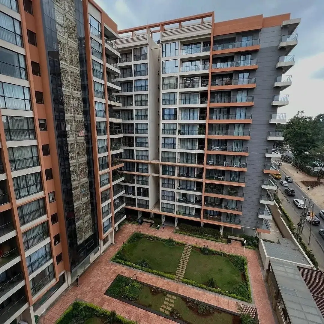 Modern multi-story residential building with landscaped courtyard
