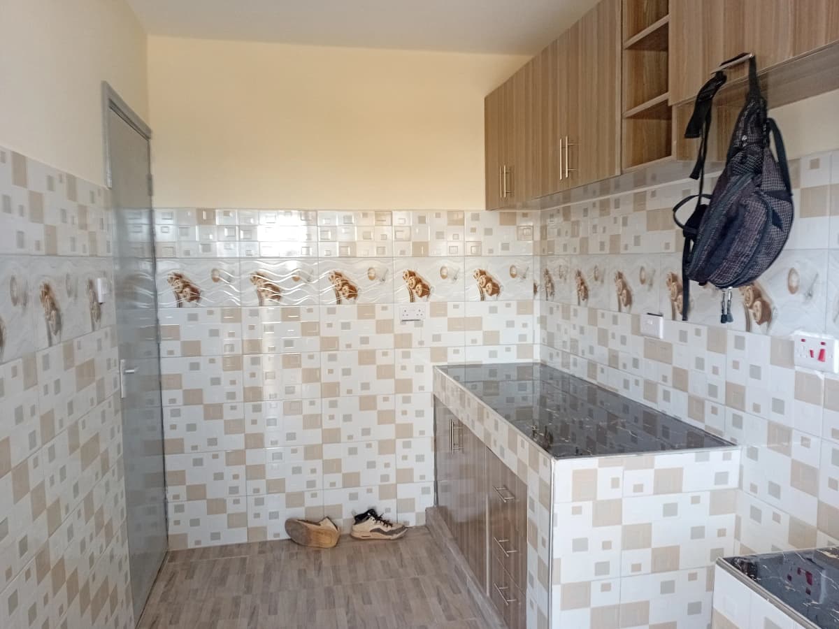 Dedicated laundry room with tiled walls and washing basin