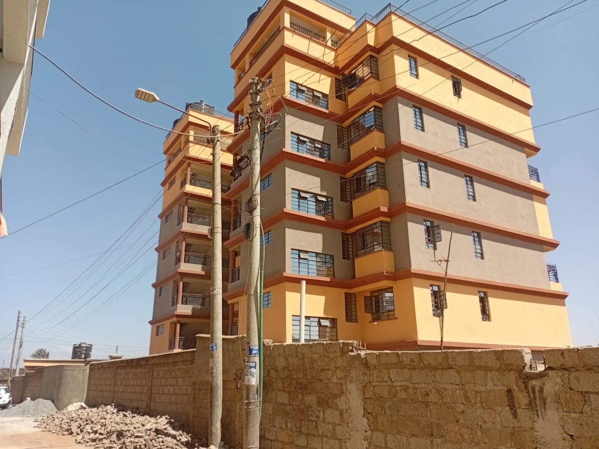 Multi-story residential building with yellow and orange facade