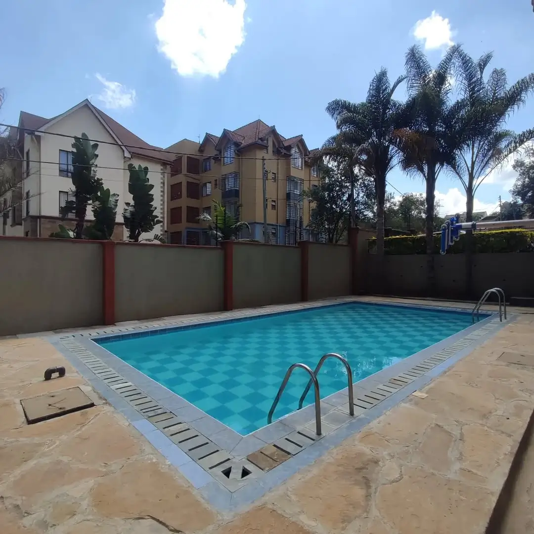 Well-maintained rectangular swimming pool with surrounding paved deck
