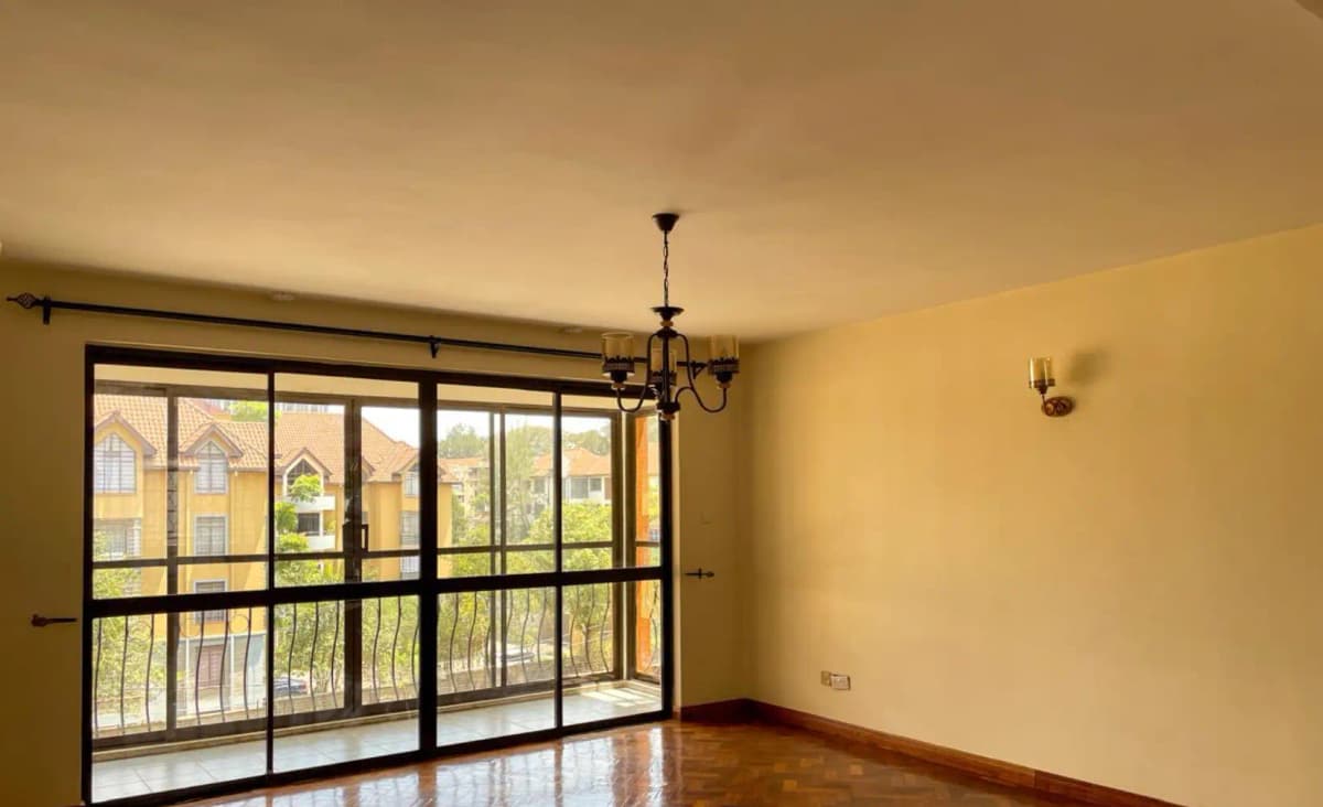 Spacious living room with large sliding glass doors overlooking balcony