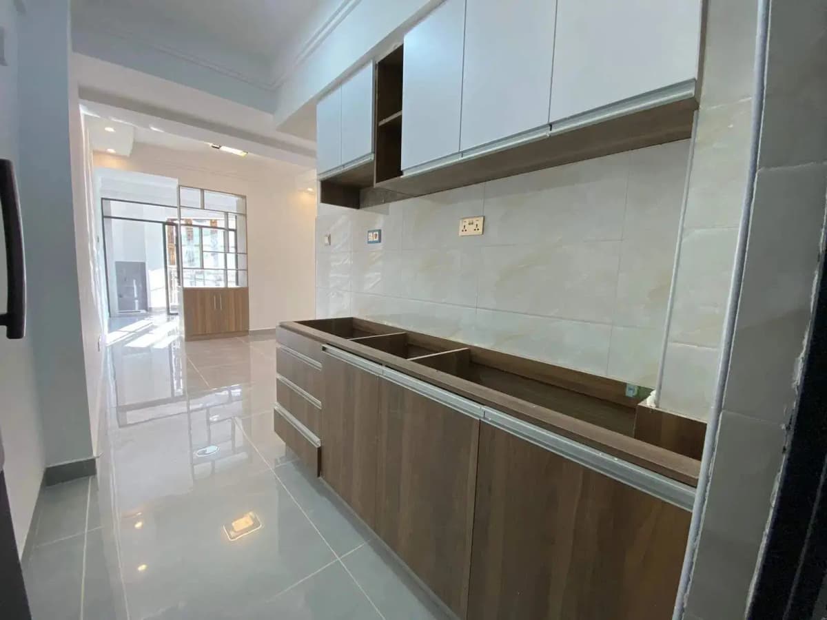 Modern galley kitchen with stainless steel appliances and white cabinetry