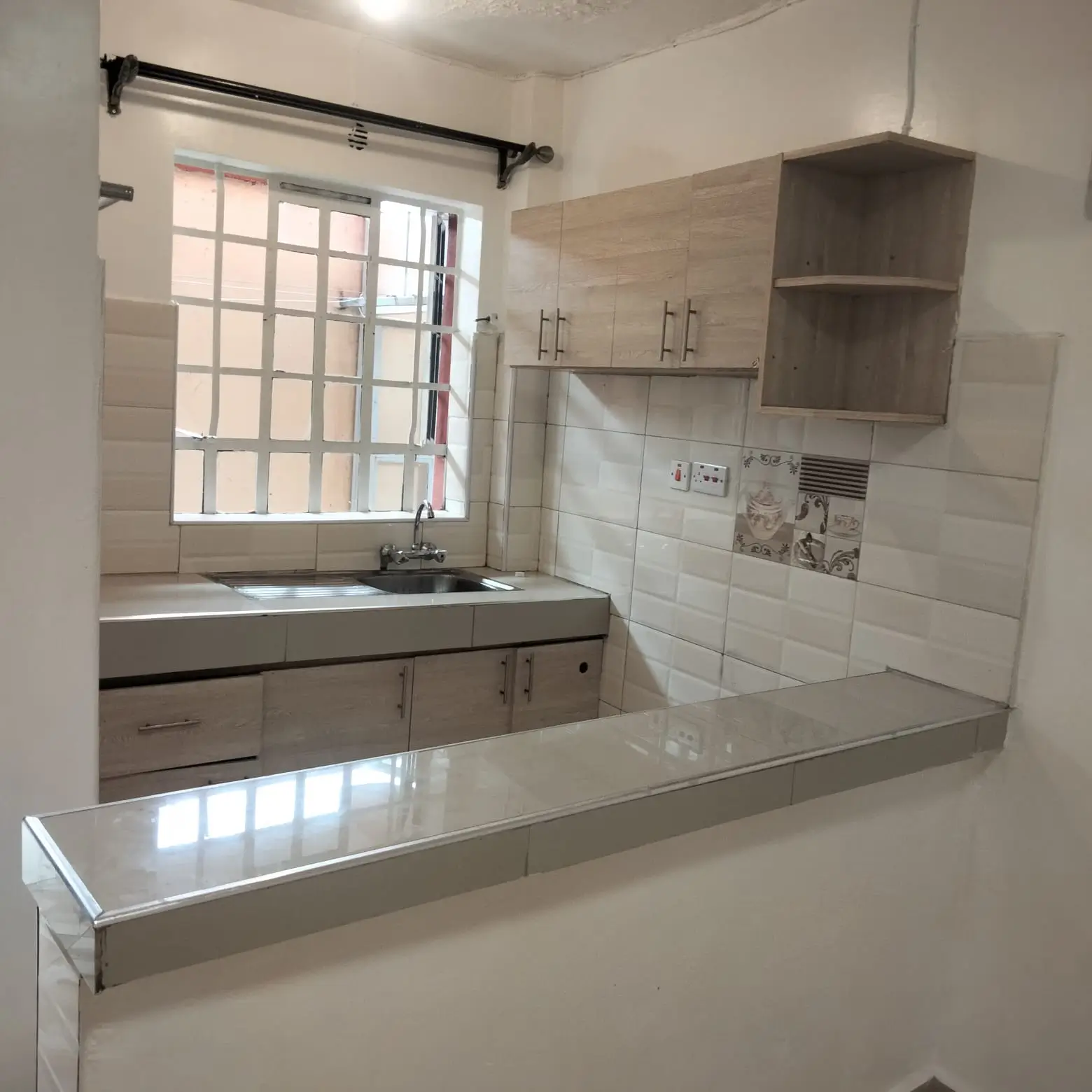 Modern kitchen with gray cabinetry and white tile backsplash
