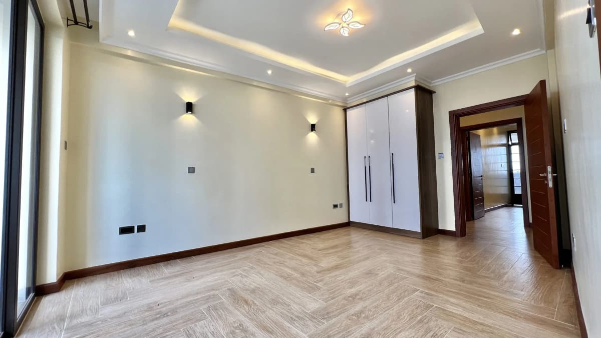 Spacious empty living room with herringbone wood flooring