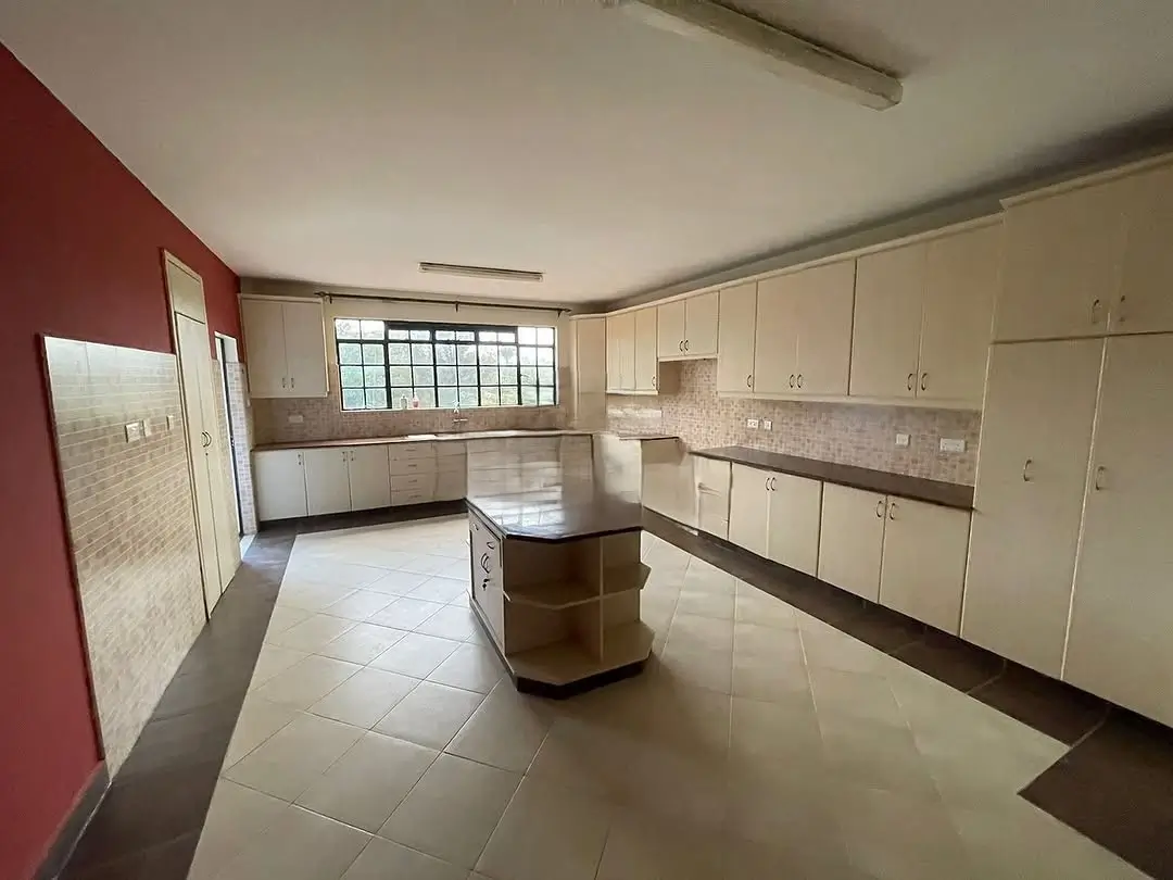 Spacious kitchen with cream cabinetry and central island