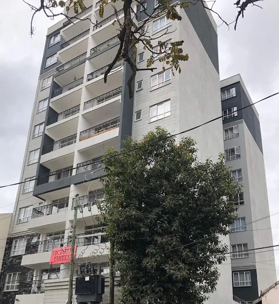 Multi-story apartment building facade with balconies and signage