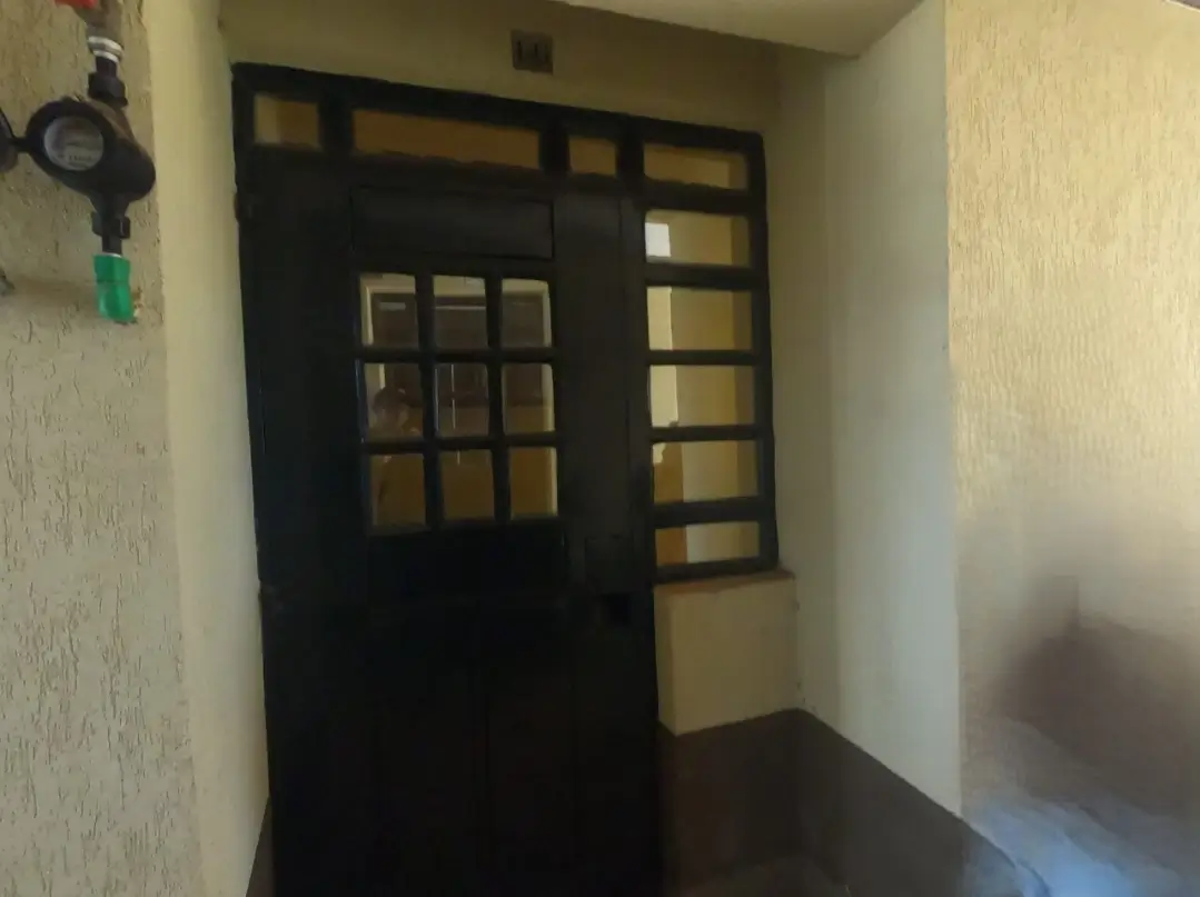 Building entrance hallway with black framed glass door
