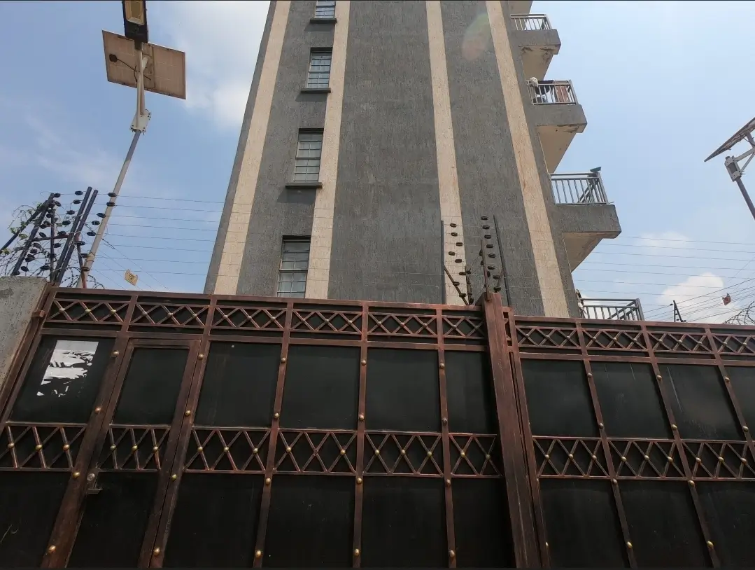 Tall residential tower with decorative metal fence and balconies