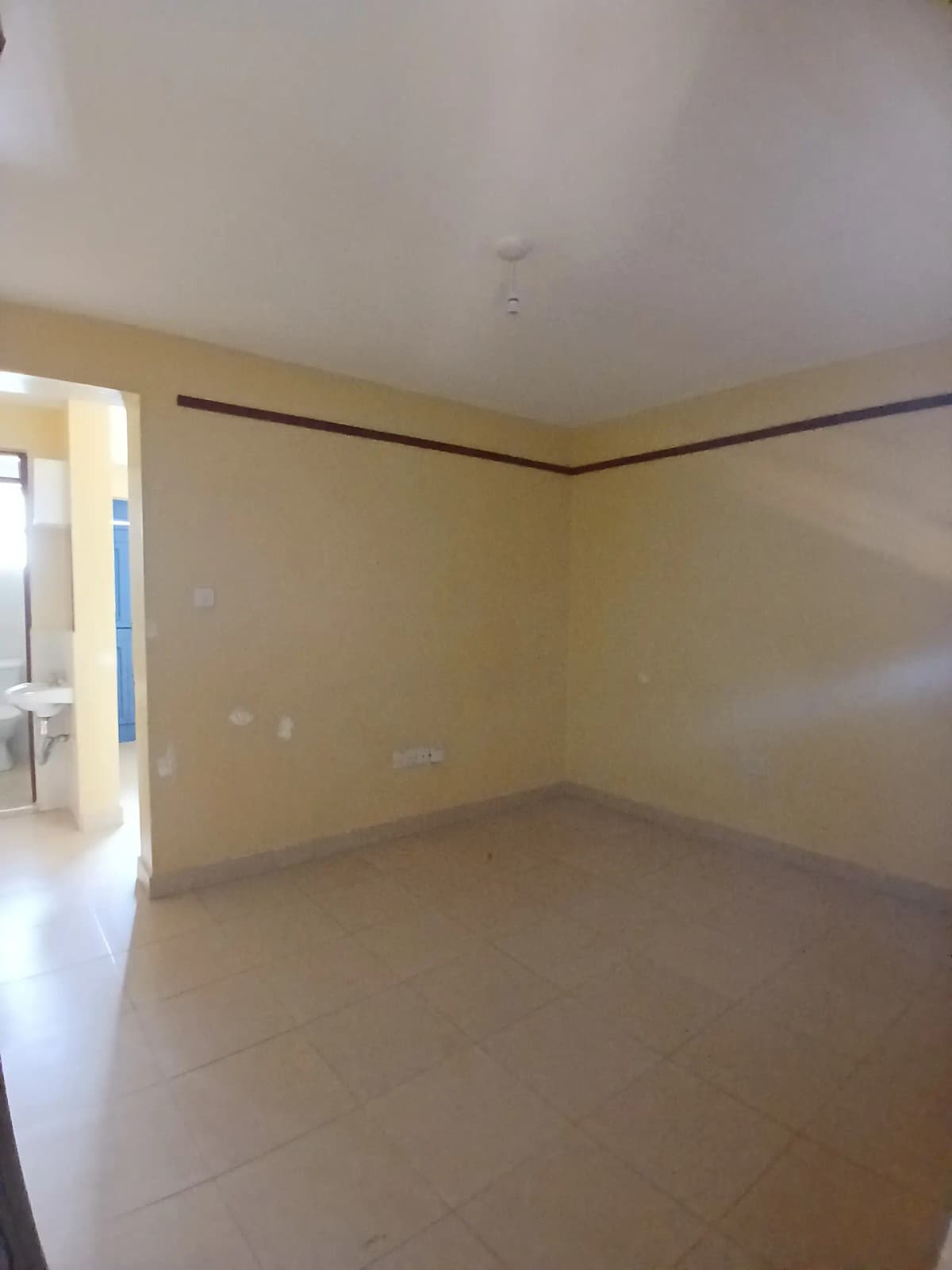 Empty living room with cream walls and polished floor
