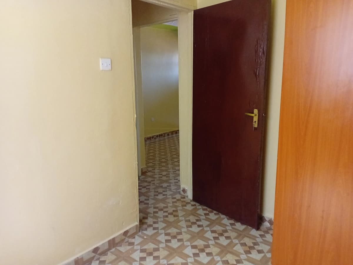 Interior hallway with patterned tile floor and wooden doors