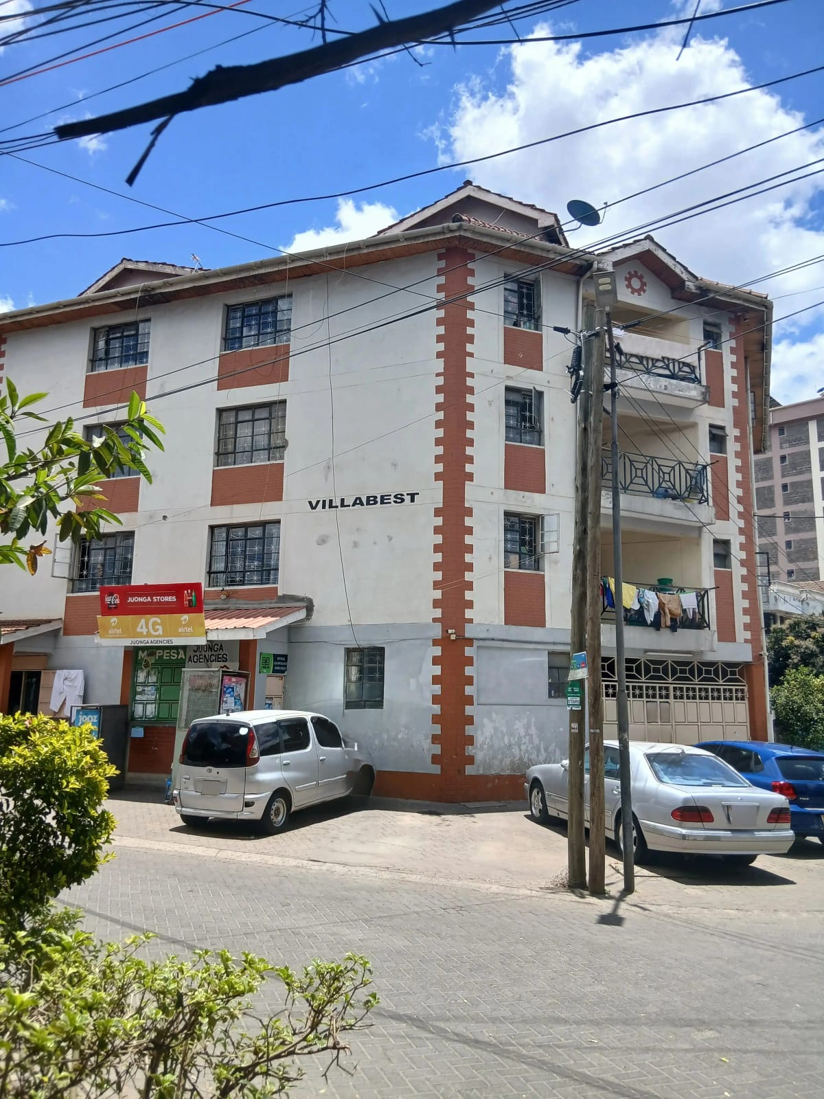 Multi-story residential building facade with red brick accents