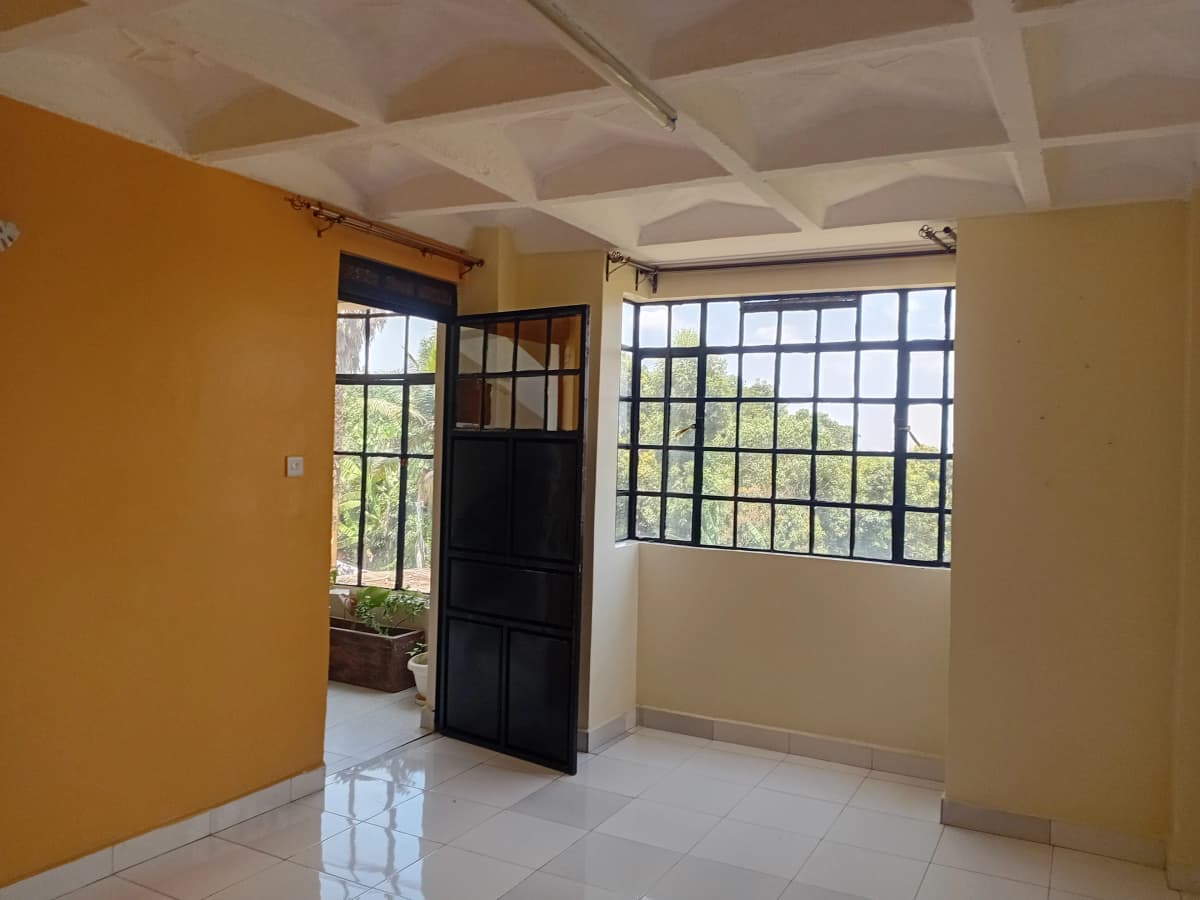 Bright living room with yellow walls and large windows