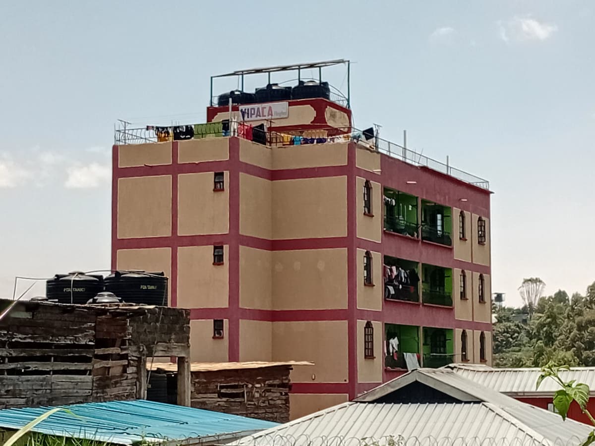 Multi-story residential building with burgundy and beige facade
