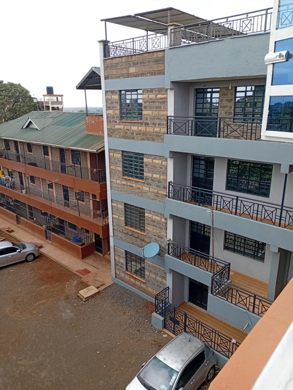 Modern multi-story residential building with brick and rendered facade