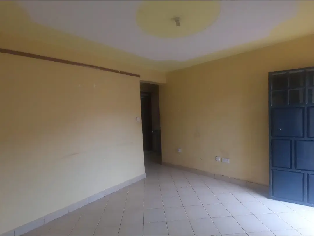 Empty living room with cream walls and blue door