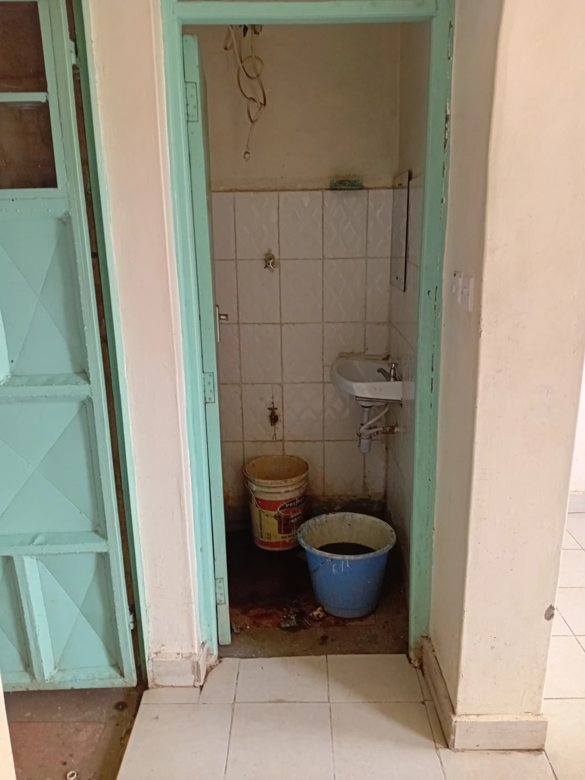Small bathroom with basic fixtures and tiled walls