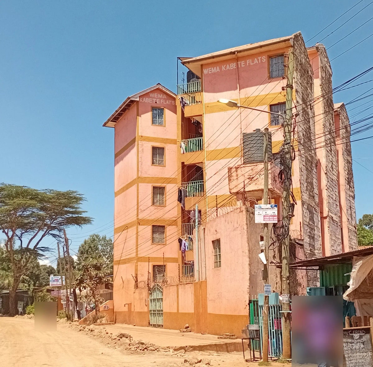 Multi-story residential building with coral and yellow facade