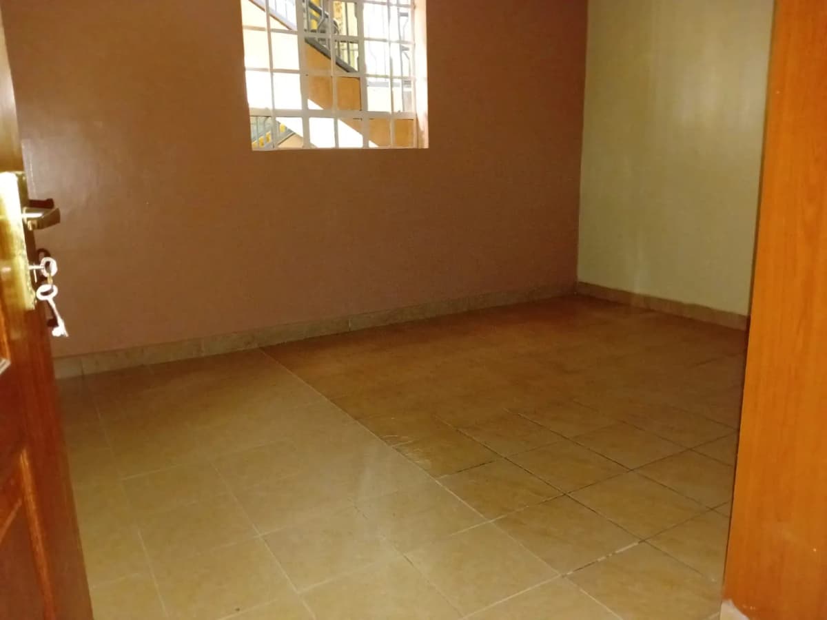 Empty bedroom with terracotta walls and tiled floor