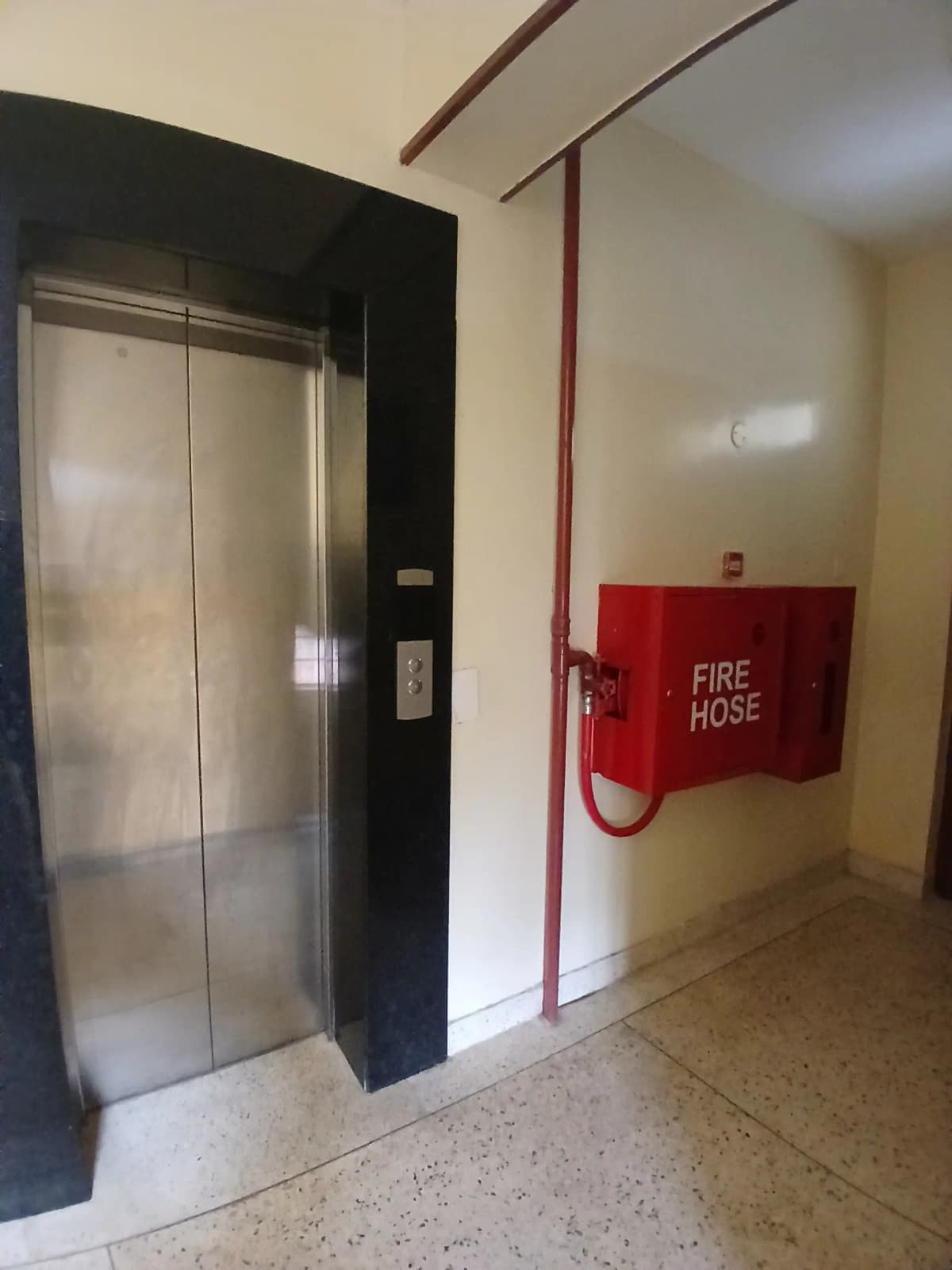 Building lobby with elevator and fire hose cabinet
