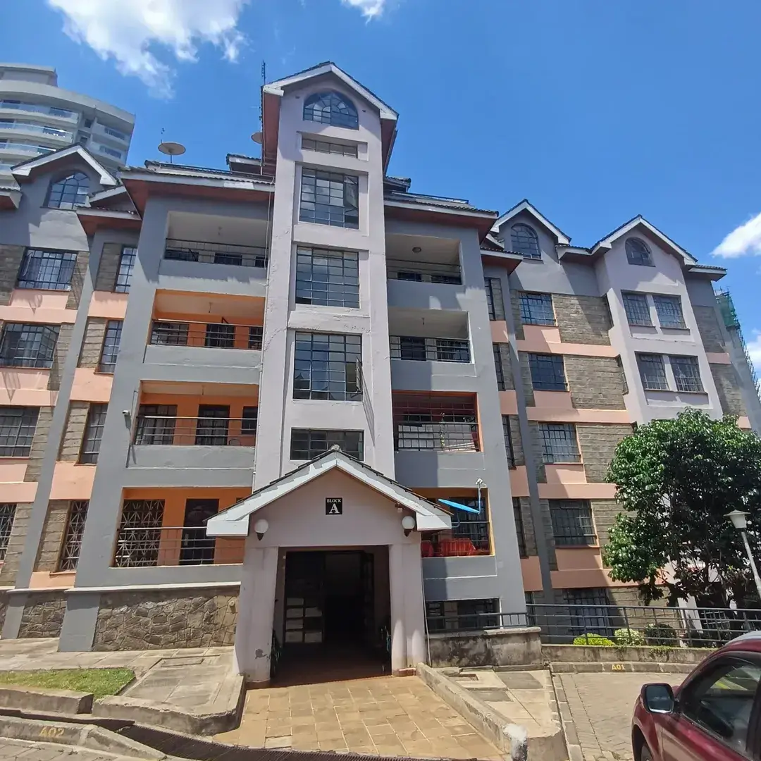 Multi-story residential building facade with balconies and entrance